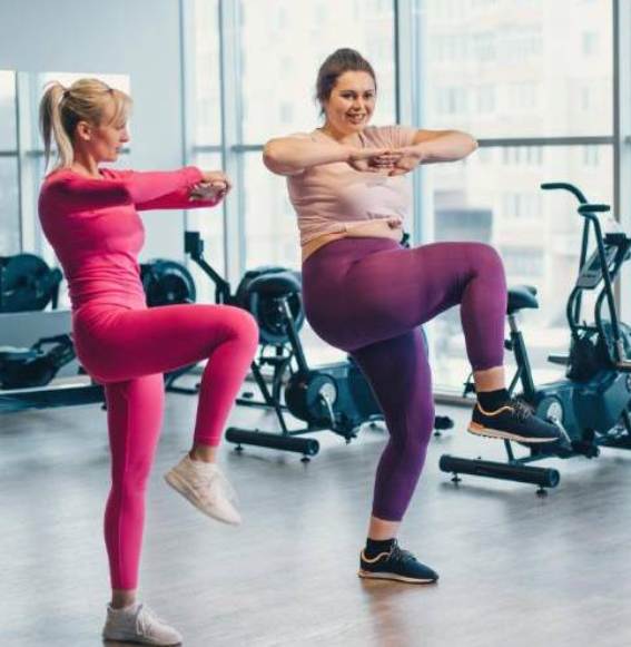 two woman doing stand up crunches
